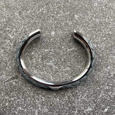 Gray leather braided cuff bracelet in polished stainless steel.