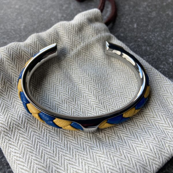 Yellow & Blue Spiral Braided Leather Cuff Bracelet Yellow and blue spiral braided leather cuff bracelet with folded edges, stainless steel setting.