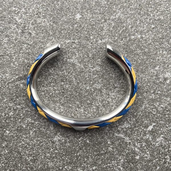 Yellow & Blue Spiral Braided Leather Cuff Bracelet Yellow and blue spiral braided leather cuff bracelet with folded edges, stainless steel setting.