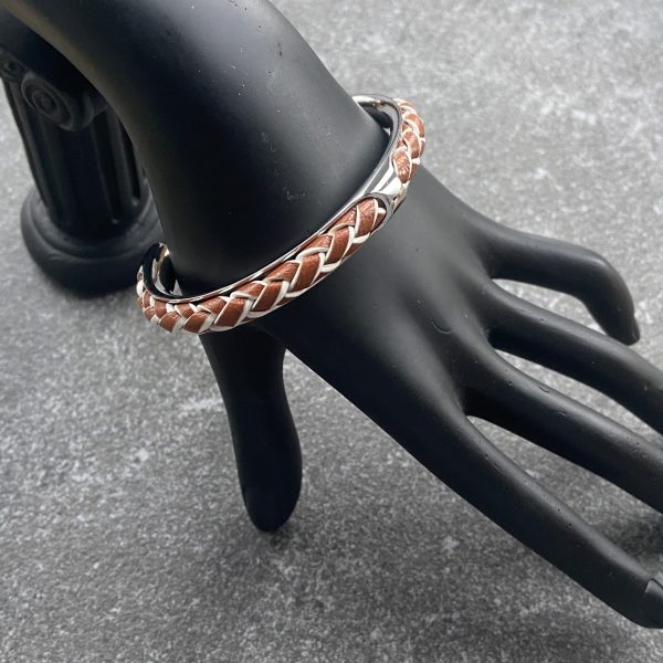 Tan and ivory braided leather cuff bracelet in polished stainless steel.