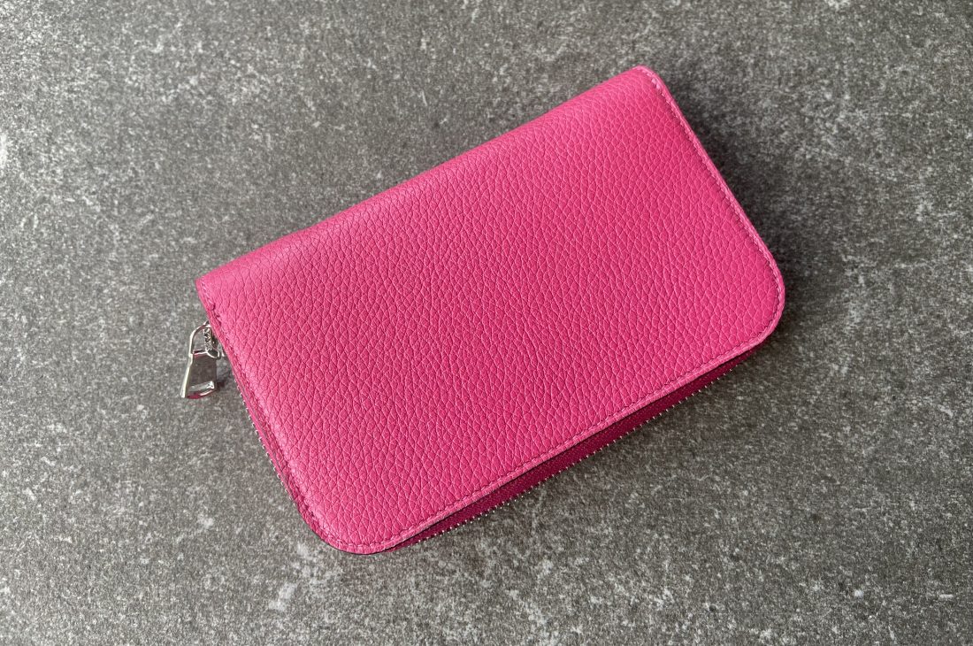 Wallet with circular zip closure