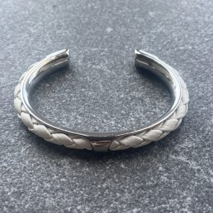 White leather braided cuff bracelet in polished stainless steel.