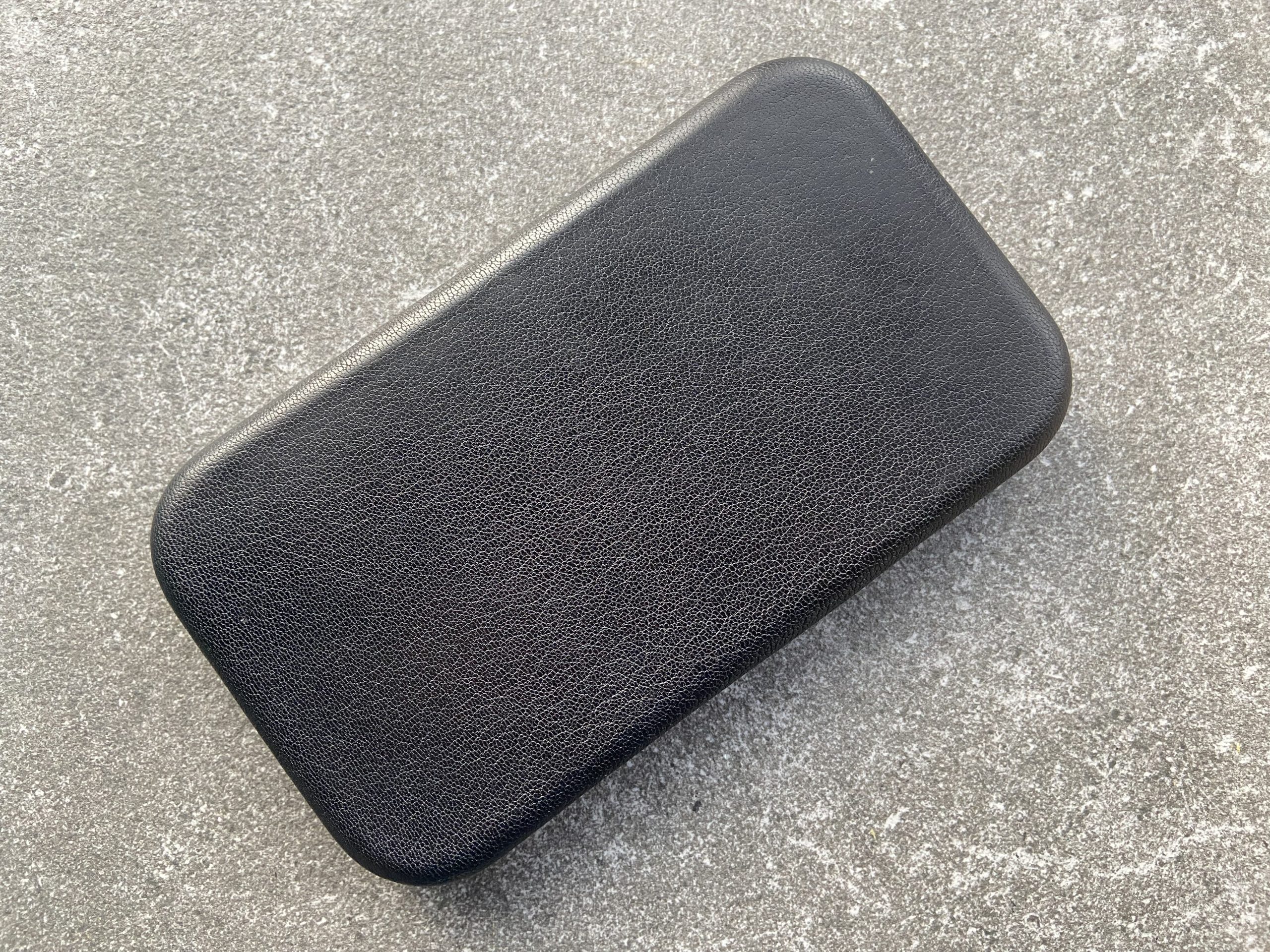 Black leather change tray on a stone surface