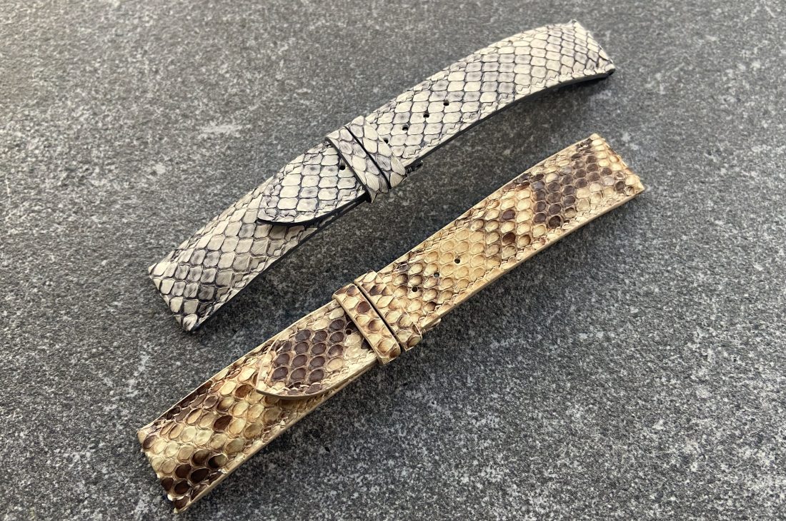 Two handcrafted python skin watch straps, one light grey and one brown.