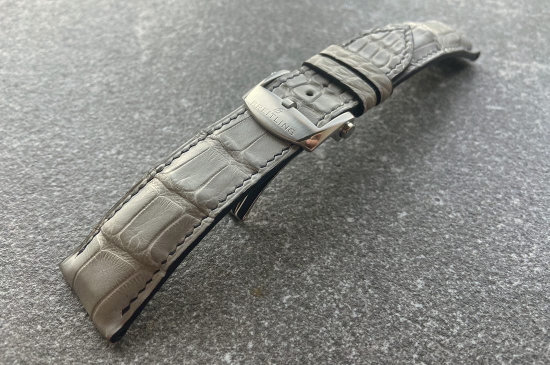 Curved grey alligator strap with hand stitching and original Breitling clasp