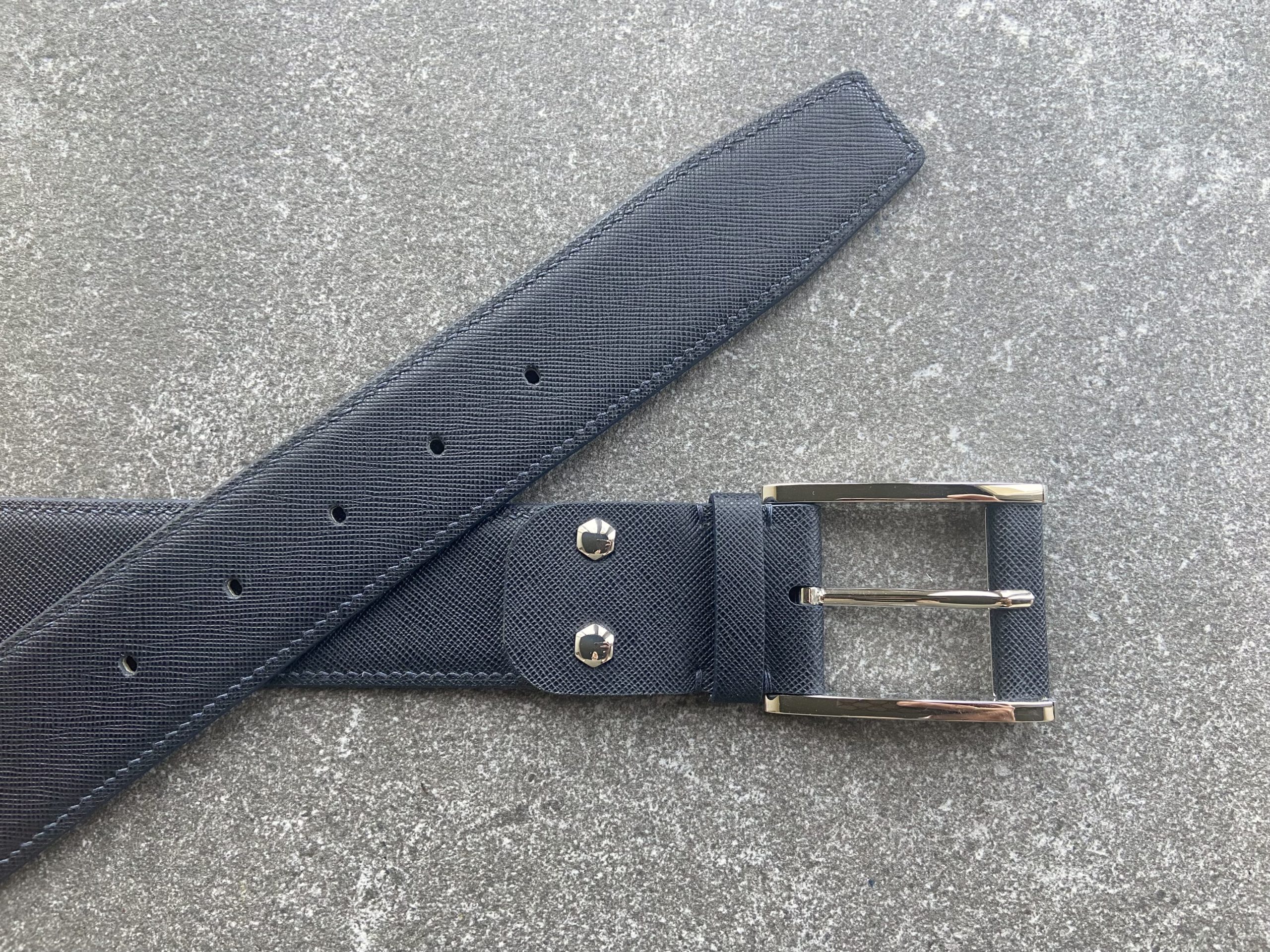 Dark navy Saffiano leather belt – angled view with buckle and tip visible