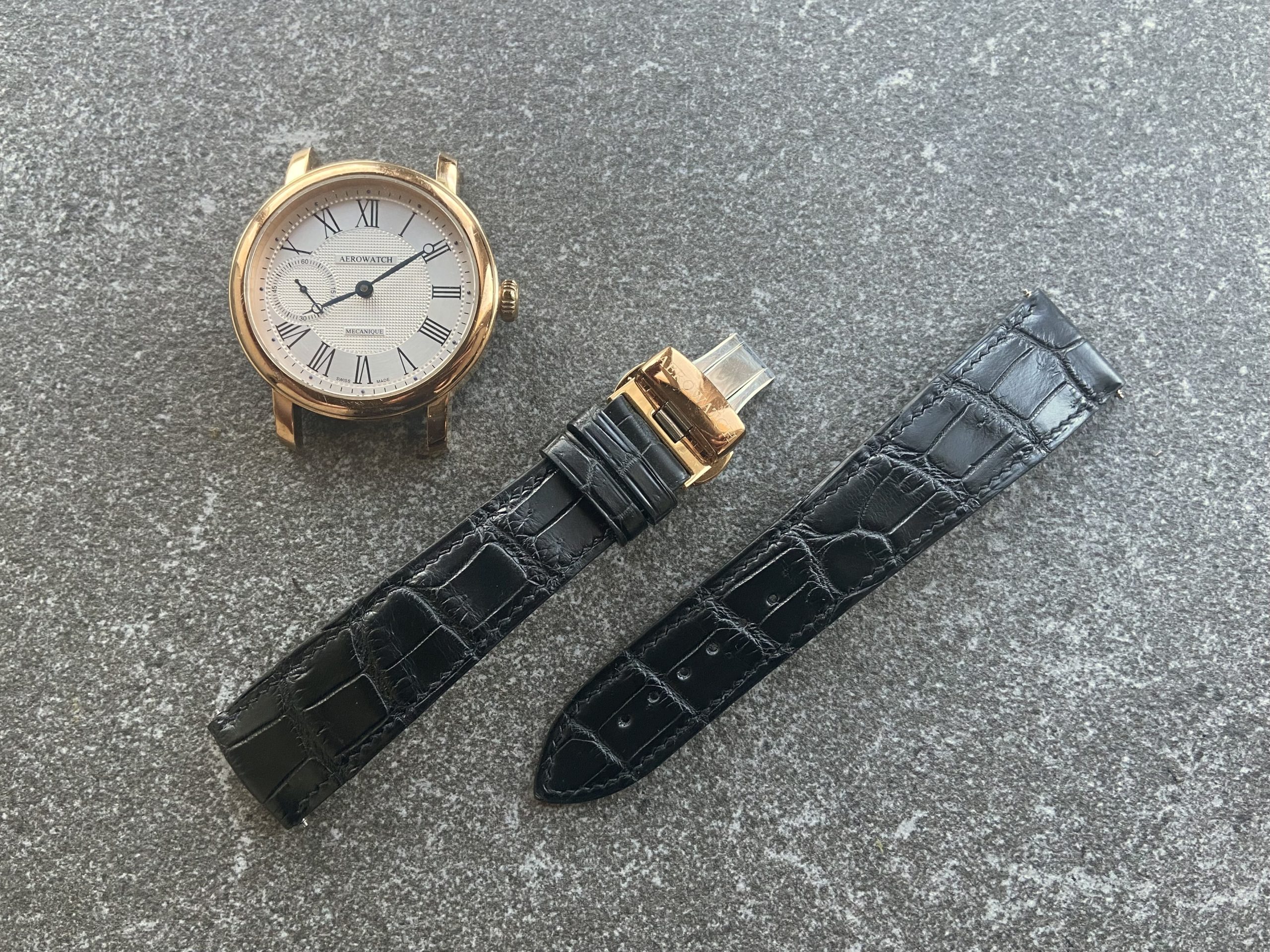 Black alligator leather strap with rose gold watch case, custom-made for a large wrist