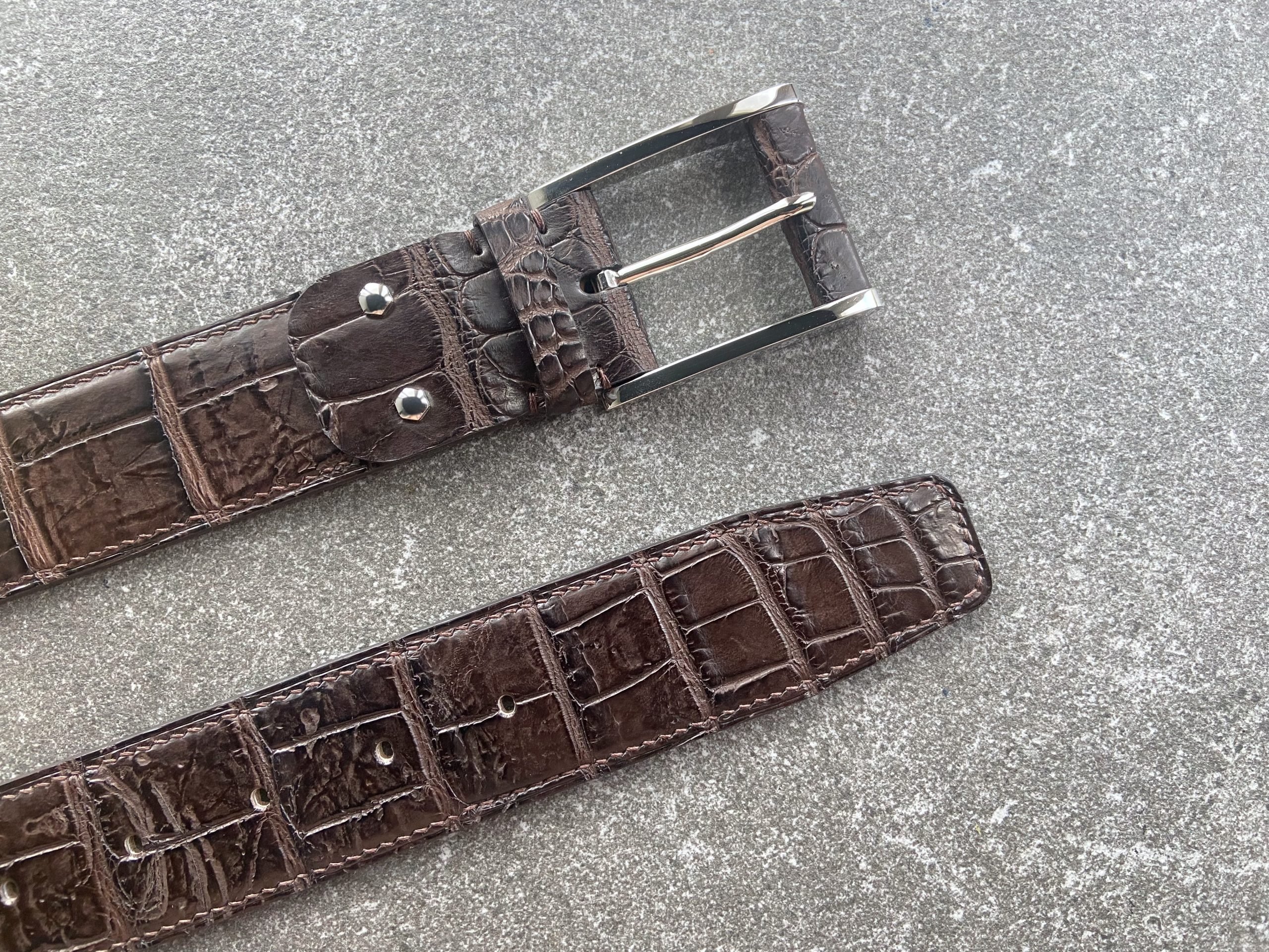 Hand-stitched alligator belt with natural scarring and Italian brass buckle