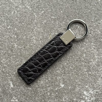 Back side of black structured grain leather key fob with polished 316L stainless steel hardware