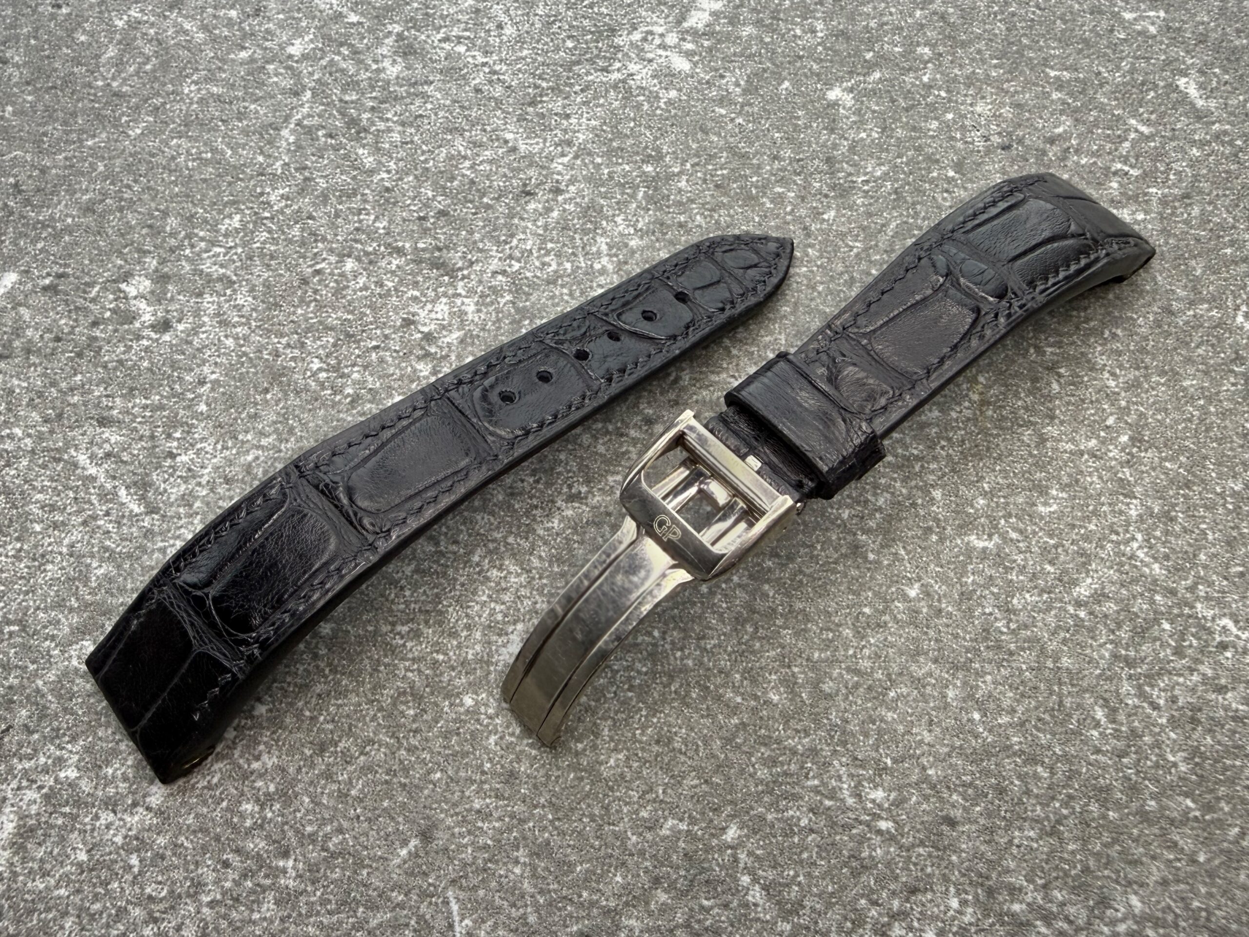 Bespoke black alligator leather strap for Girard-Perregaux Richeville with the original 18K white-gold deployant clasp, shown from the top side.