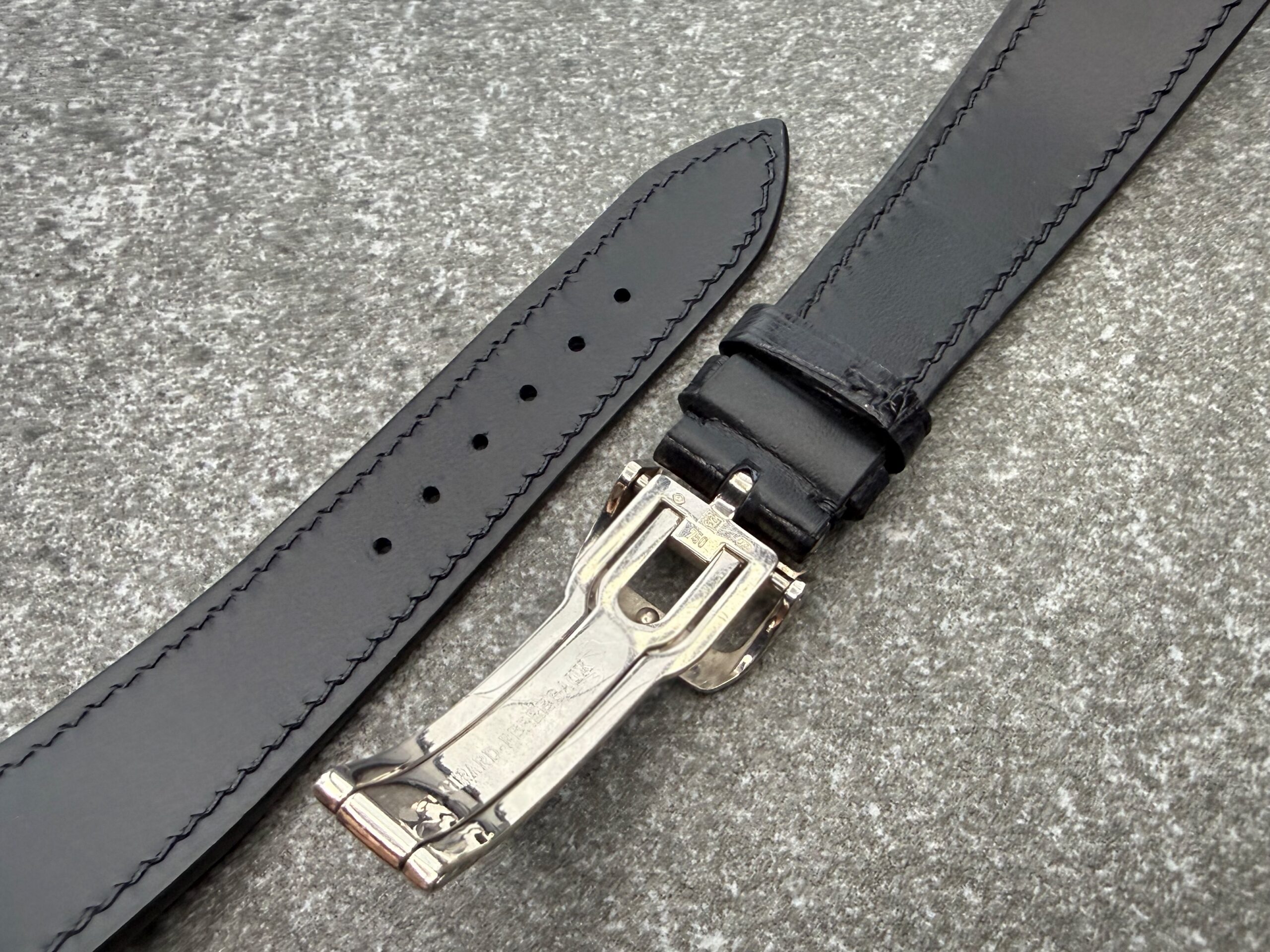 Bespoke black alligator strap with black water-resistant lining and hand stitching, shown with the original Girard-Perregaux deployant clasp in 18K white gold.