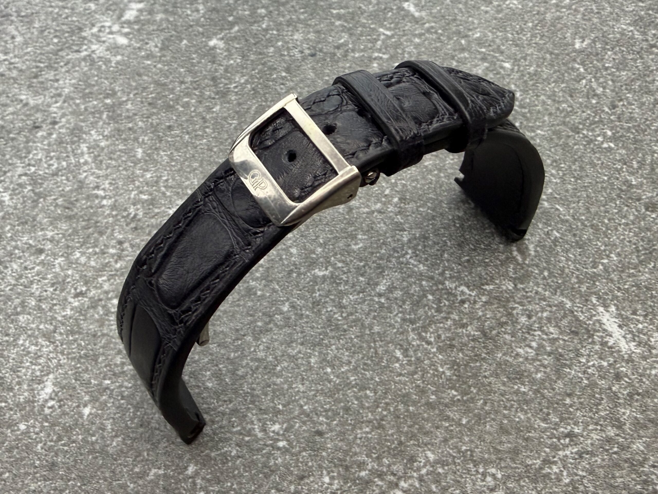 Bespoke black alligator leather strap shaped with ergonomic curvature, shown with the original GP clasp for Girard-Perregaux Richeville.