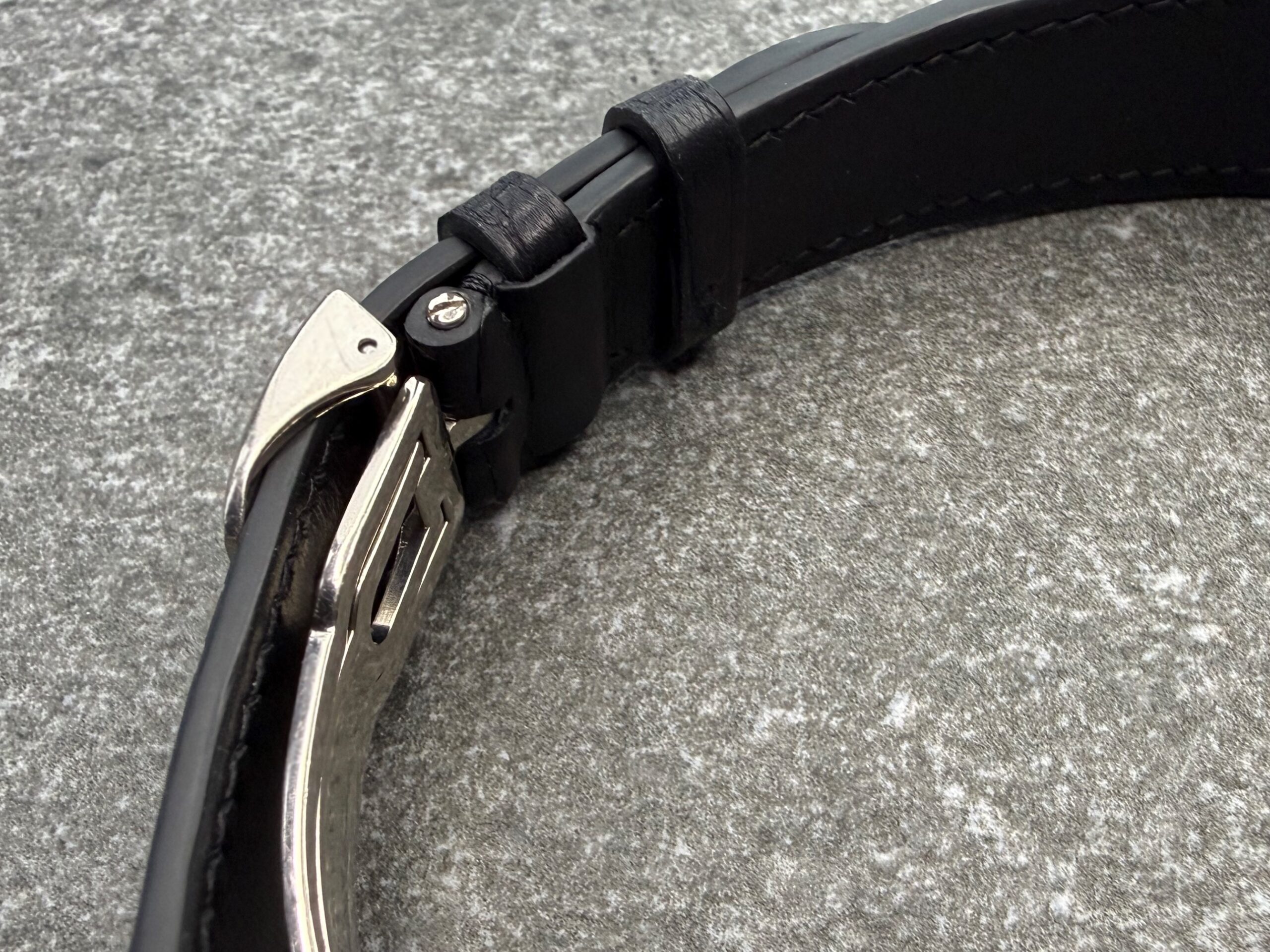 Black alligator leather strap fitted to a Girard-Perregaux Richeville case, showing the tight integrated end and the clean transition from metal to leather.