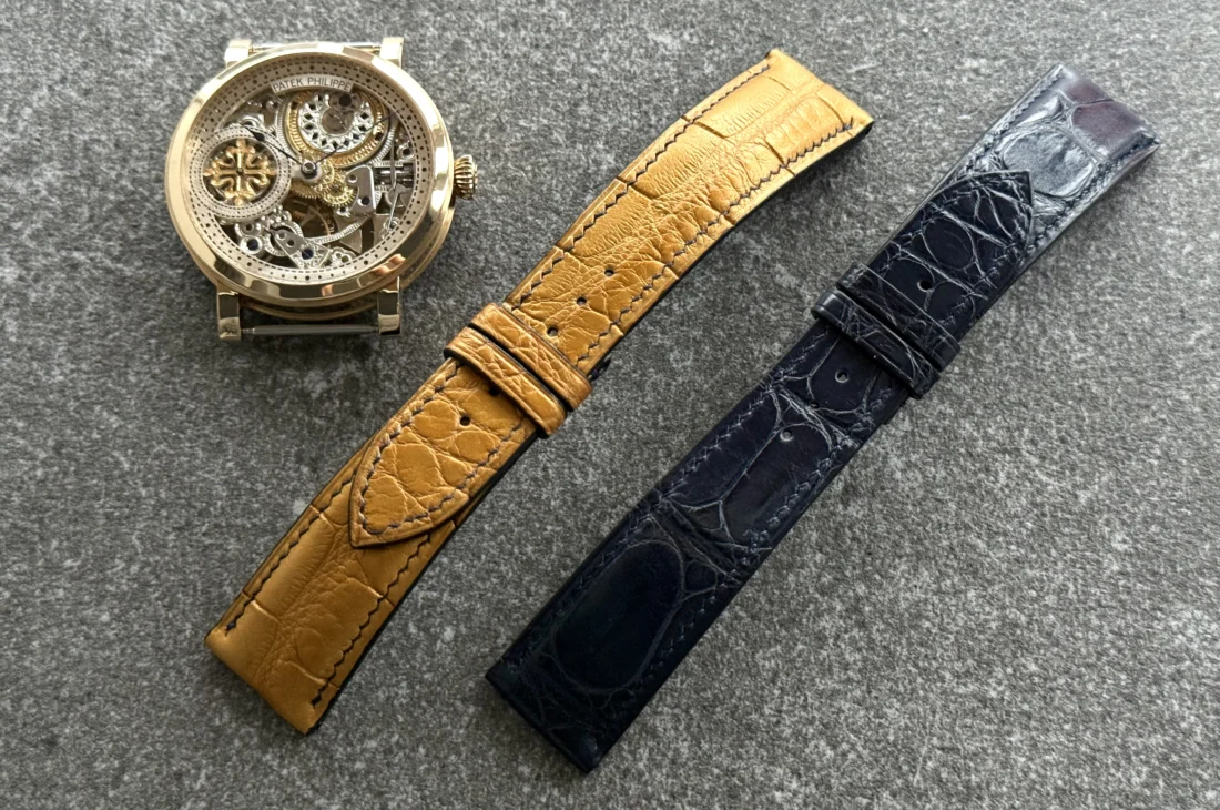 Custom alligator leather watch straps for the Equilibrium project — golden tone strap with transverse cut and deep blue alligator strap designed for a gold folding clasp