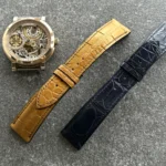 Custom alligator leather watch straps for the Equilibrium project — golden tone strap with transverse cut and deep blue alligator strap designed for a gold folding clasp