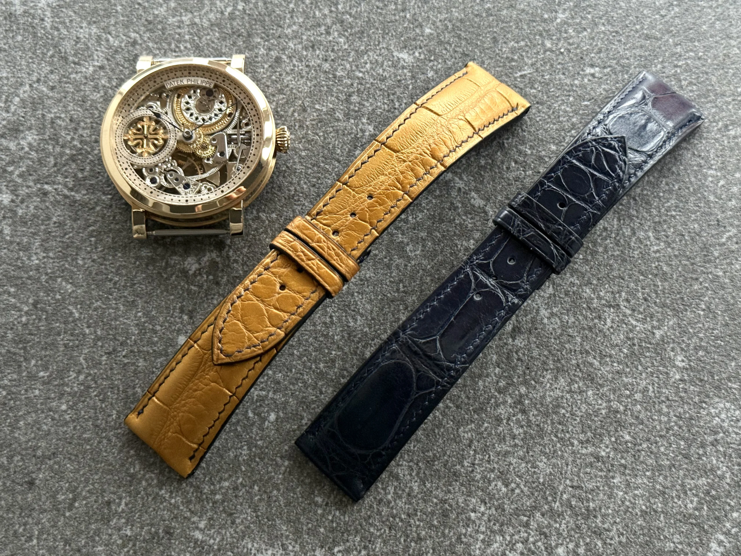 Custom alligator leather watch straps for the Equilibrium project — golden tone strap with transverse cut and deep blue alligator strap designed for a gold folding clasp