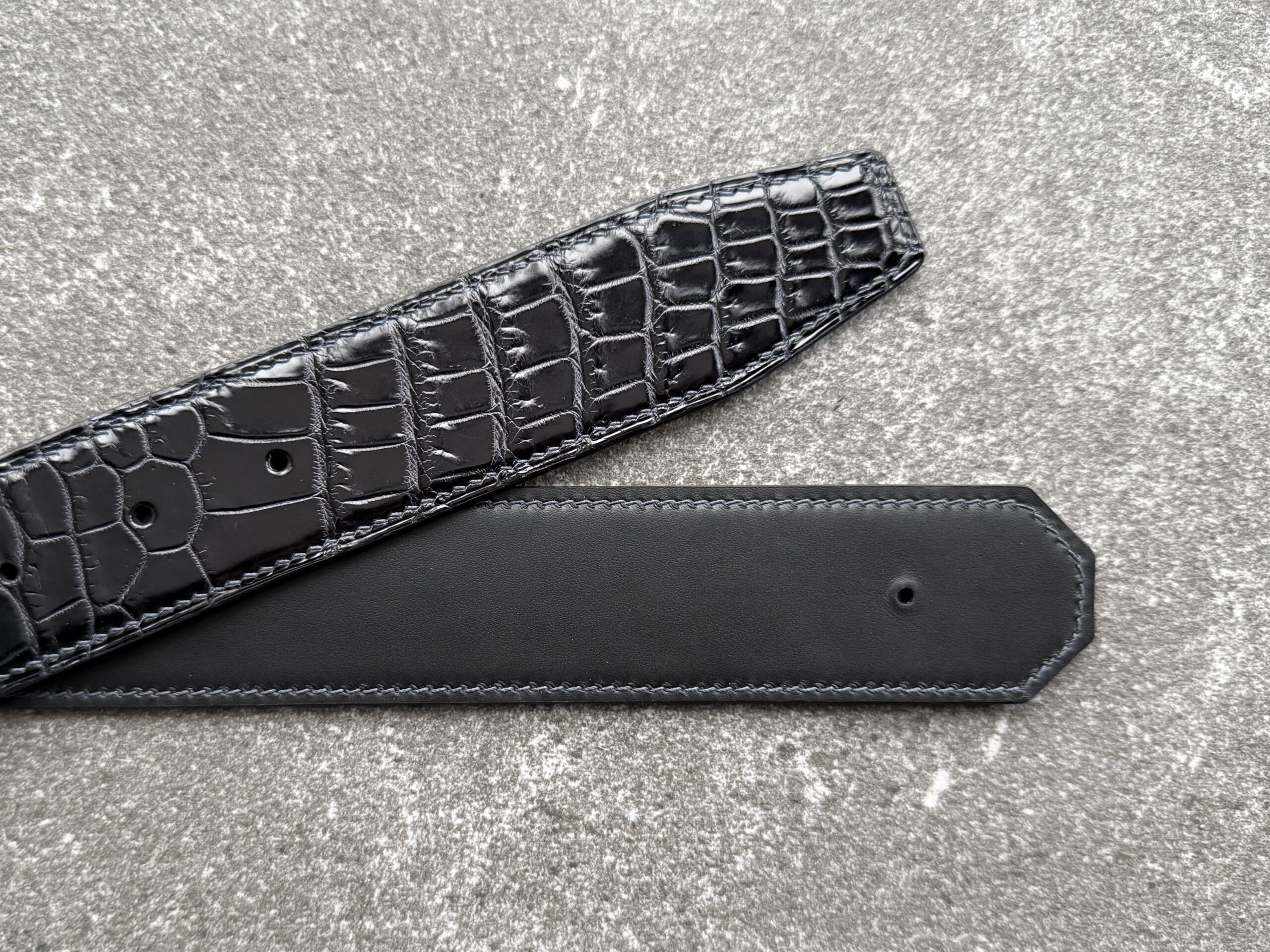 Bespoke crocodile belt strap with smooth leather lining, hand saddle stitching and clean tip shape
