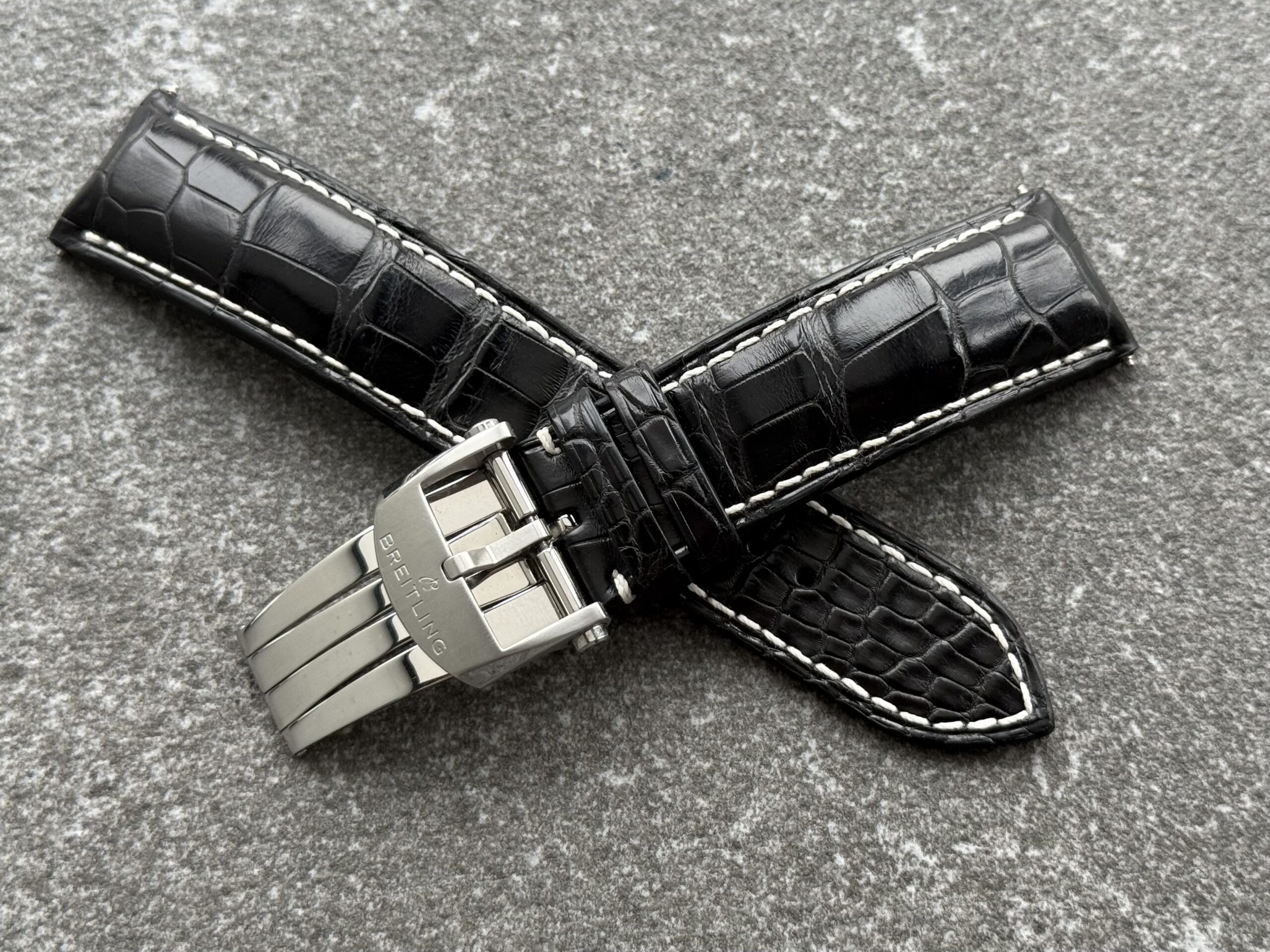 Black alligator strap for Breitling Avenger B01 with light contrast stitching and original Breitling deployant clasp, open view